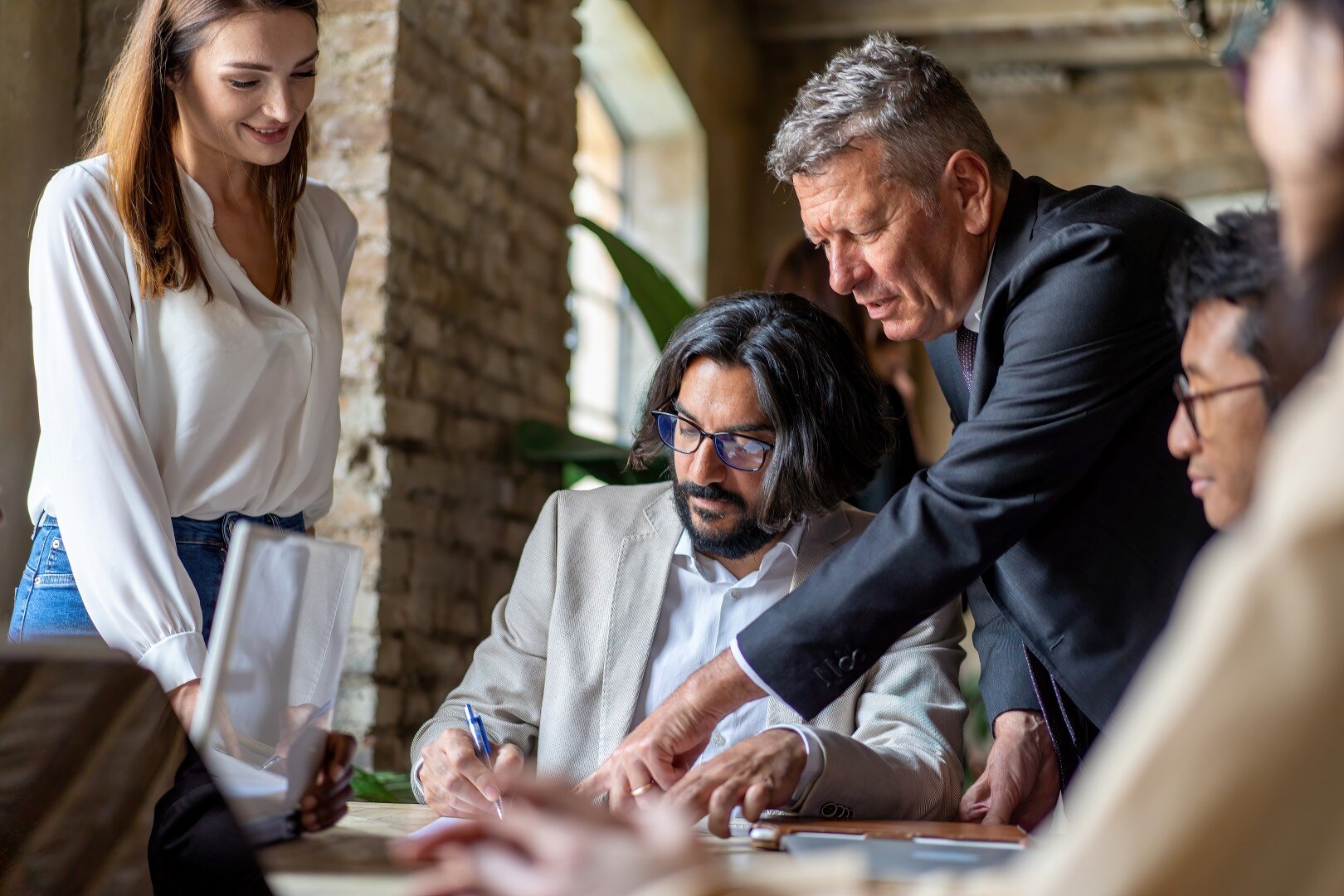 diverse-team-signing-a-professional-agreement-in-a-2025-03-05-06-41-19-utc (Custom)